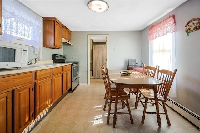 kitchen featuring electric stove, a baseboard heating unit, and sink