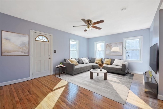 living room featuring ceiling fan, a healthy amount of sunlight, and light hardwood / wood-style floors