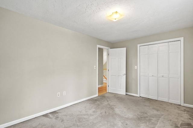 184 Burlingame Rd, Charlton, MA 01507 - unfurnished bedroom featuring carpet, a closet, a textured ceiling, and baseboards