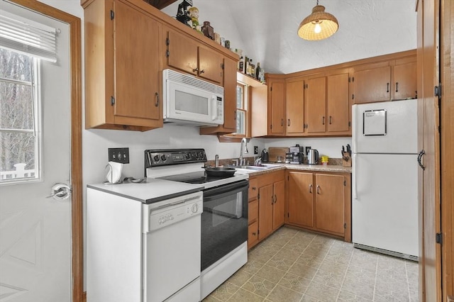 184 Burlingame Rd, Charlton, MA 01507 - kitchen featuring brown cabinetry, white appliances, light countertops, and a sink