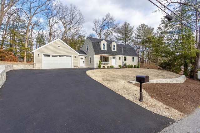 cape cod home featuring a garage