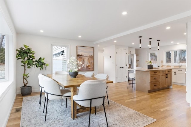 dining room with light wood-type flooring and sink