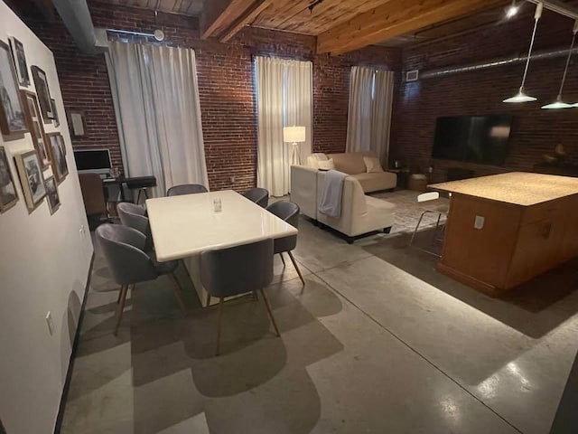 130 John Unit 213, Lowell, MA 01852 - dining room with brick wall, concrete floors, and wooden ceiling with exposed beams