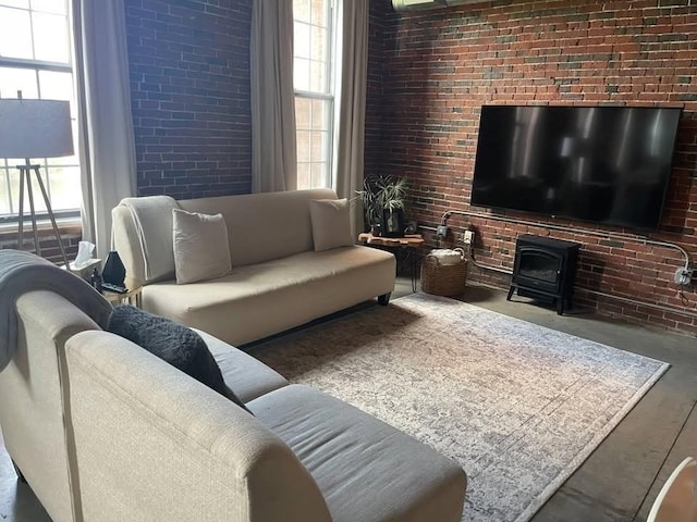 130 John Unit 213, Lowell, MA 01852 - living area featuring a wood stove and brick wall