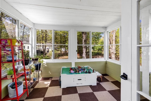 sunroom / solarium with tile patterned floors and plenty of natural light