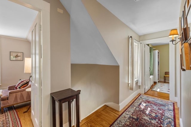 hallway with wood finished floors and baseboards