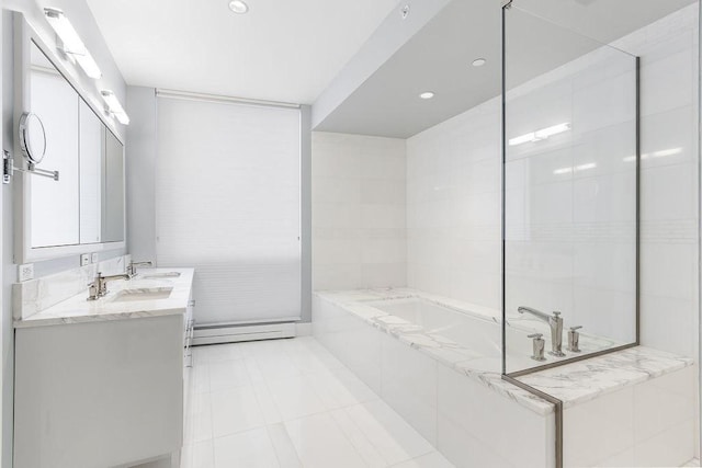 bathroom featuring tile patterned floors, a garden tub, baseboard heating, and vanity