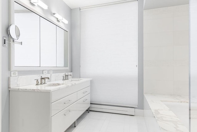 full bathroom with double vanity, a baseboard radiator, and a sink