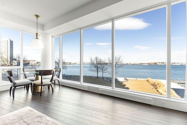 sunroom featuring plenty of natural light and a water view