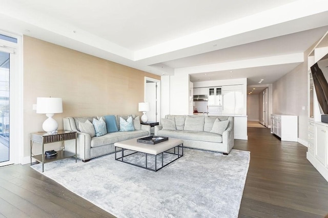 living room with dark wood-type flooring and baseboards