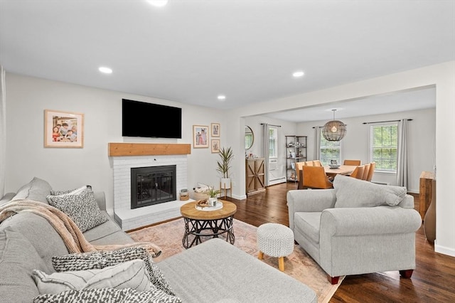 10 Old Broad St, Holden, MA 01522 - living area with dark wood-type flooring, baseboards, recessed lighting, and a brick fireplace