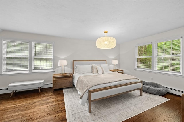 10 Old Broad St, Holden, MA 01522 - bedroom featuring wood finished floors and a baseboard heating unit
