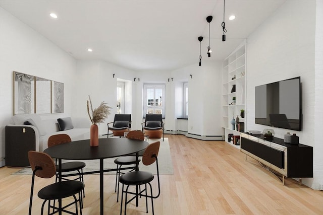 dining space featuring light hardwood / wood-style flooring and built in features