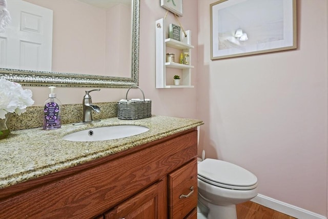 26 Gaslight Ln Unit 26, Easton, MA 02356 - half bathroom featuring vanity, baseboards, toilet, and wood finished floors
