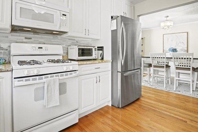 26 Gaslight Ln Unit 26, Easton, MA 02356 - kitchen featuring white appliances, white cabinets, decorative backsplash, light wood finished floors, and ornamental molding