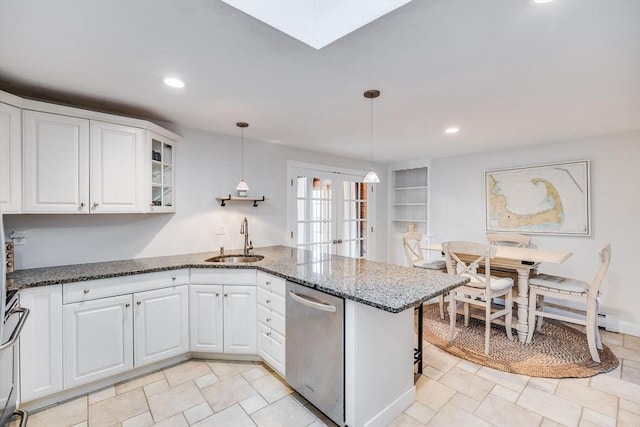 kitchen featuring a sink, white cabinetry, french doors, appliances with stainless steel finishes, and a peninsula