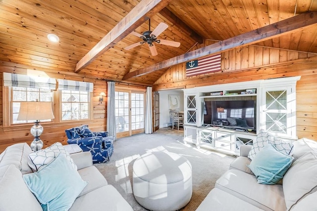 living room with wooden walls, a ceiling fan, carpet floors, lofted ceiling with beams, and wood ceiling