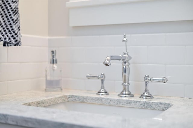 room details with decorative backsplash and a sink