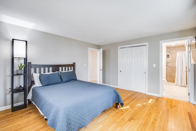 bedroom featuring a closet, baseboards, and light wood finished floors