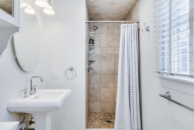 full bath featuring a sink and a shower stall