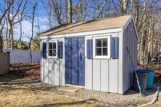 view of shed featuring fence