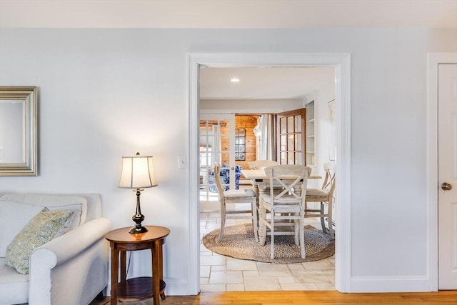 dining area with light wood-style flooring and baseboards