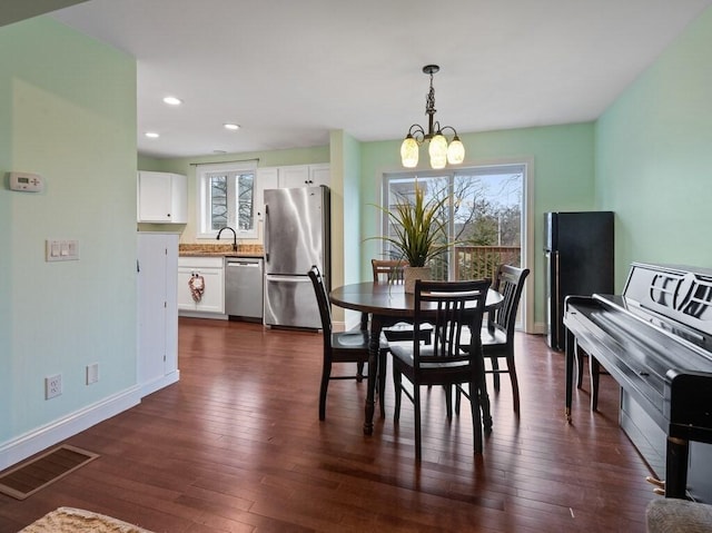 dining room featuring dark hardwood / wood-style flooring and a chandelier