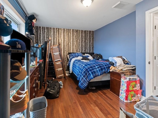 bedroom with wood-type flooring