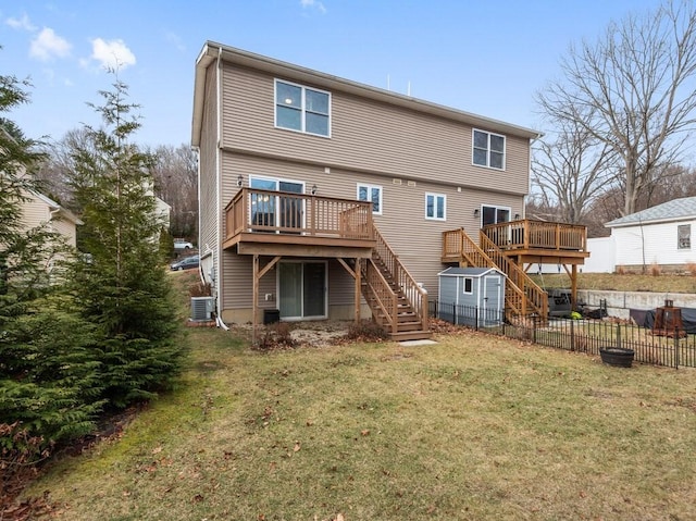 rear view of property with a deck, a yard, a shed, and cooling unit