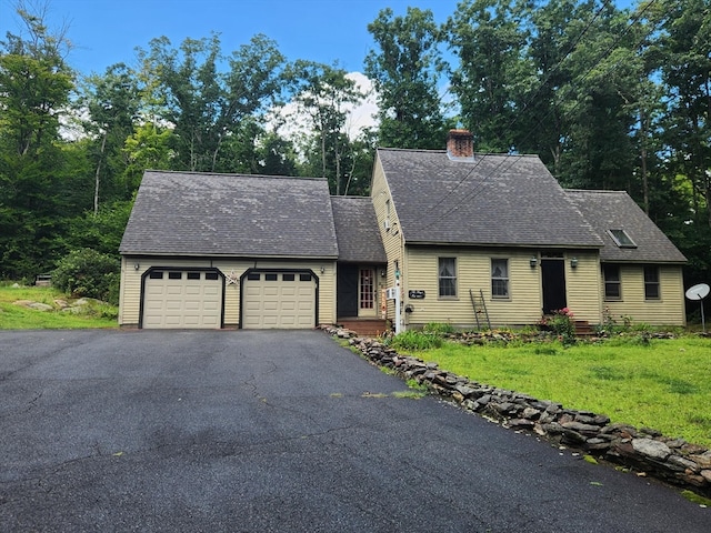 view of front facade with a garage and a front lawn