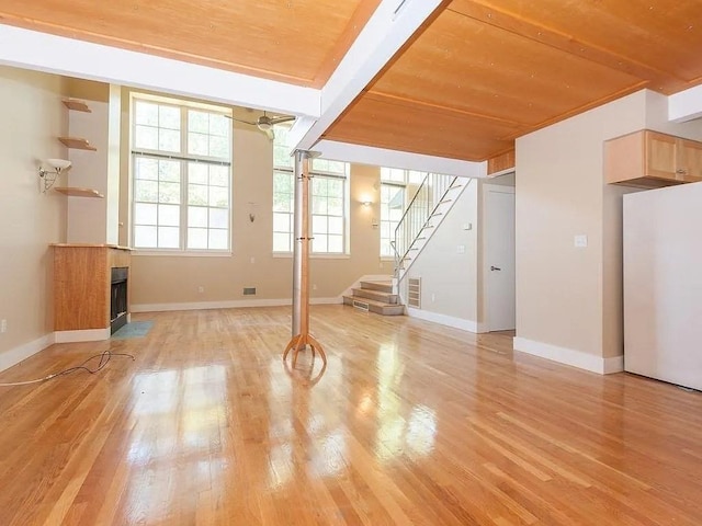 155 Brookline Unit 2, Cambridge, MA 02139 - unfurnished living room with wooden ceiling, light wood-style floors, stairway, baseboards, and a fireplace with flush hearth