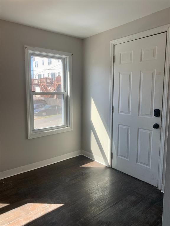 interior space with dark wood-style floors and baseboards