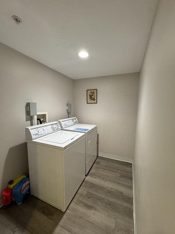 laundry room with light wood-style flooring, laundry area, washer and clothes dryer, and baseboards