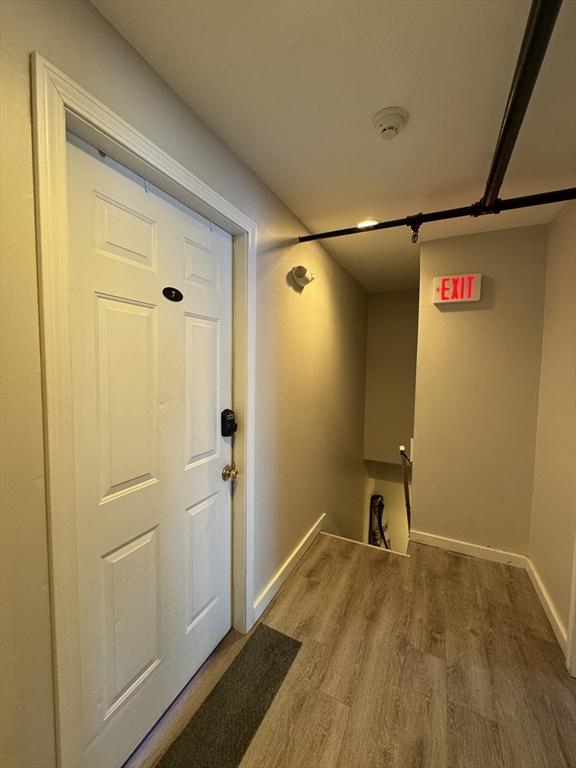 interior space featuring baseboards and wood finished floors