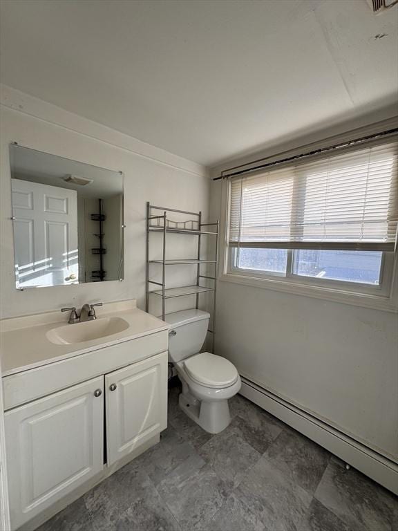 half bath with a baseboard heating unit, vanity, and toilet