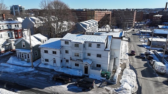 snowy aerial view with a residential view