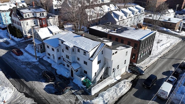 snowy aerial view with a residential view