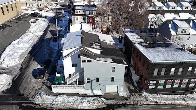 snowy aerial view featuring a residential view