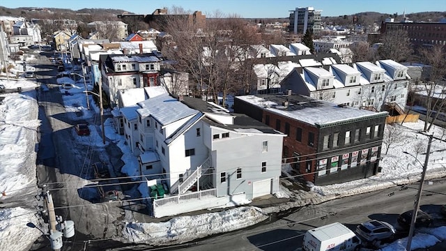 snowy aerial view with a residential view