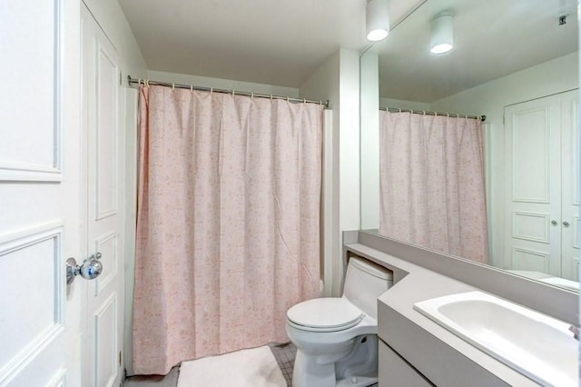 full bathroom featuring vanity and toilet