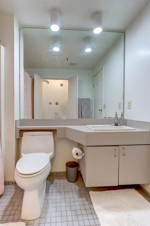 full bath featuring vanity and toilet