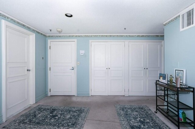foyer featuring carpet flooring