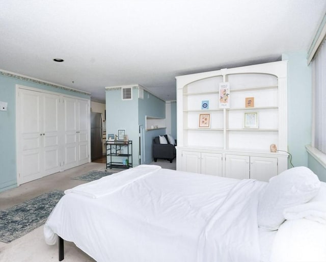 bedroom with freestanding refrigerator