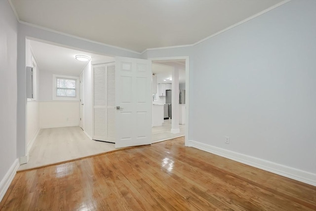 73 Laurie Ave, Abington, MA 02351 - empty room with light wood finished floors, baseboards, and ornamental molding