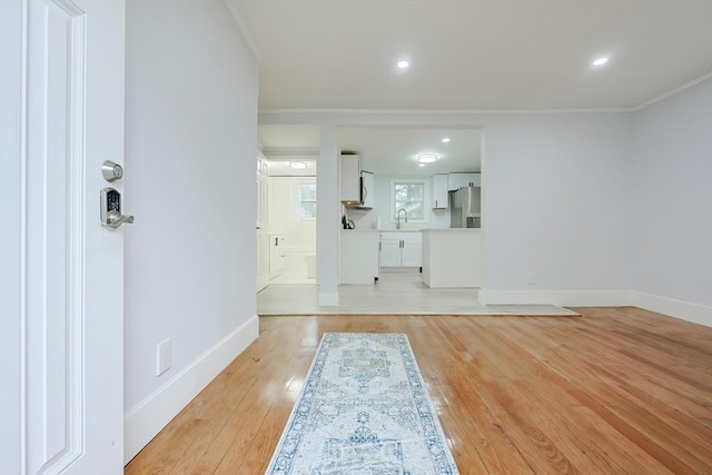 73 Laurie Ave, Abington, MA 02351 - unfurnished living room featuring baseboards, a sink, ornamental molding, light wood-type flooring, and recessed lighting
