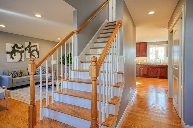 stairway with hardwood / wood-style flooring