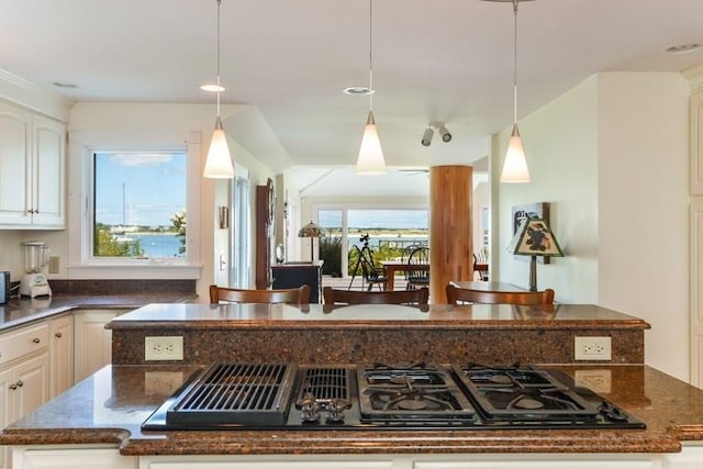188 S St, Yarmouth, MA 02664 - kitchen with white cabinetry, pendant lighting, black gas stovetop, and dark stone counters