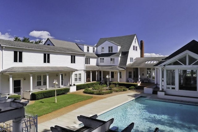 188 S St, Yarmouth, MA 02664 - rear view of house with an outdoor pool and a patio area