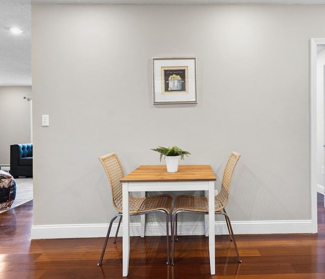 dining space featuring dark wood-type flooring