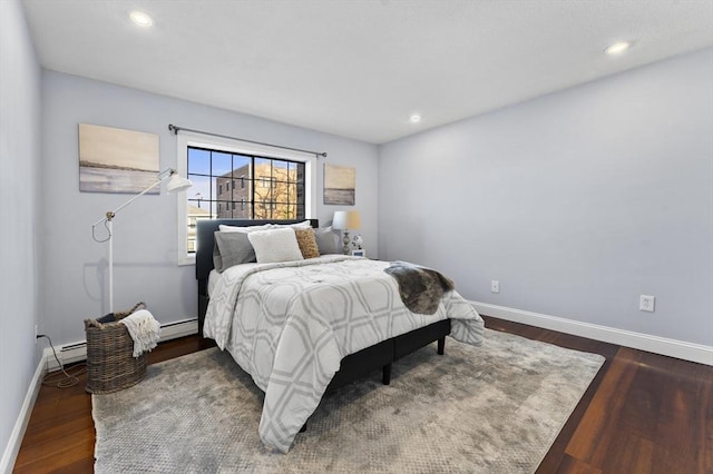 bedroom featuring a baseboard radiator and dark hardwood / wood-style flooring